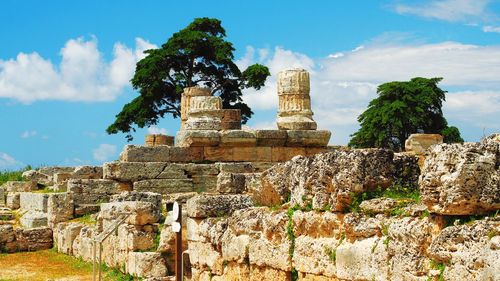 Old ruins of temple against cloudy sky