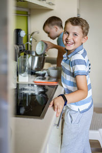 Cute brothers doing chores at home