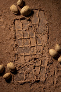 Dark chocolate background by chocolate pieces, whole raw almonds and cocoa powder