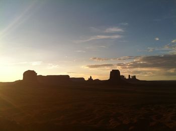 Monument valley against sky during sunset