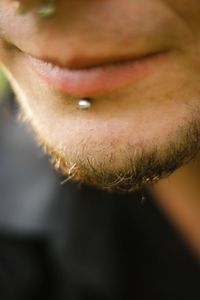 Cropped image of man with piercing