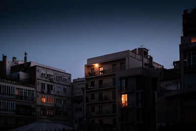 Low angle view of buildings against sky at dusk