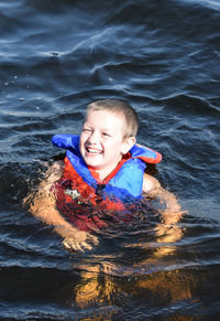 High angle view of smiling boy in sea
