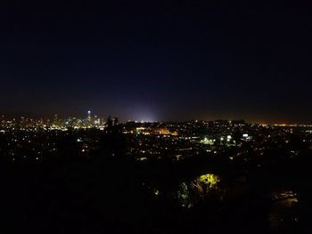 High angle view of illuminated buildings against sky at night