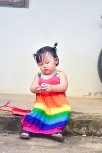 High angle view of cute girl sitting on floor