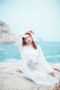 Portrait of smiling young woman on beach