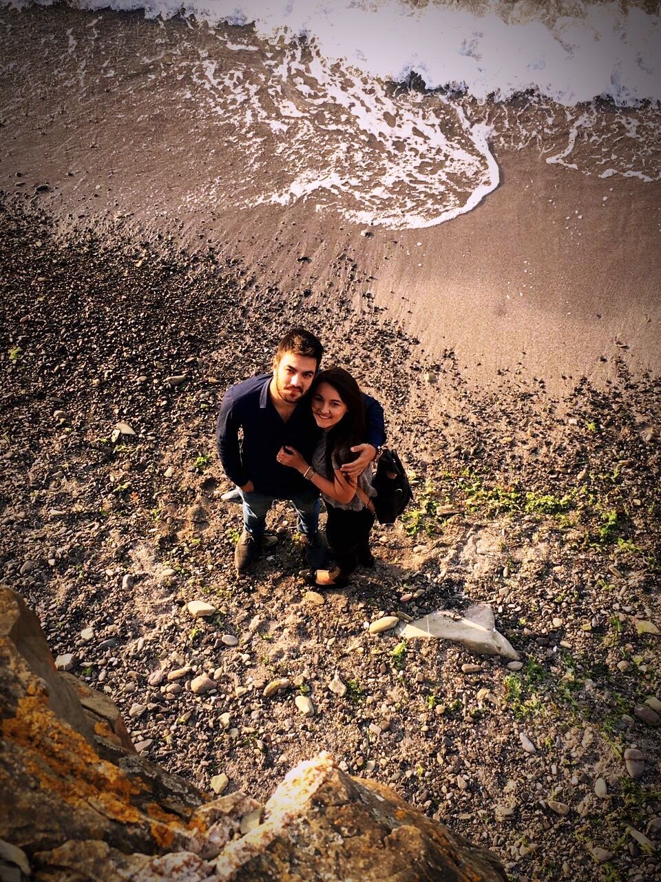 two people, real people, high angle view, togetherness, leisure activity, day, outdoors, nature, full length, young women, water, lifestyles, vacations, standing, looking at camera, beach, portrait, young adult, beauty in nature, people