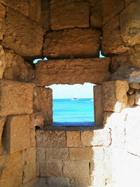 Stone wall of building by sea