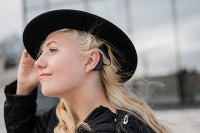 Portrait of beautiful young woman in hat