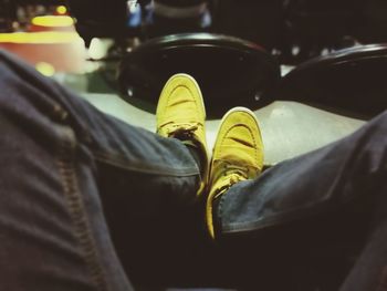 Low section of man wearing shoes