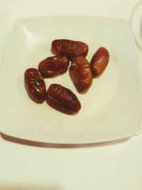 High angle view of coffee beans in plate