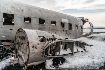 Abandoned airplane on snow covered land