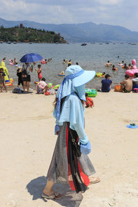 People on beach against sky