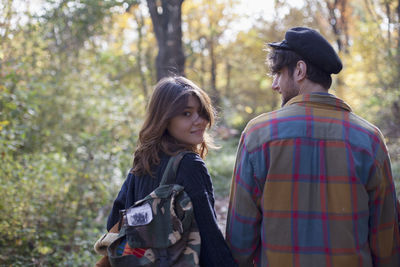 Young couple walking through a park