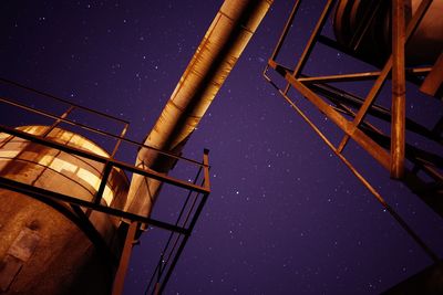 Low angle view of illuminated built structure against clear sky at night