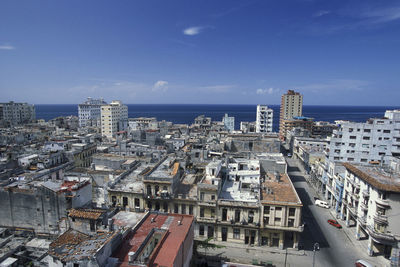 High angle view of buildings against blue sky