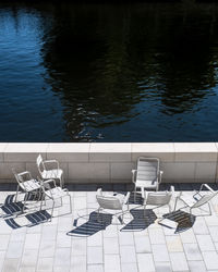 High angle view of chairs and table in swimming pool