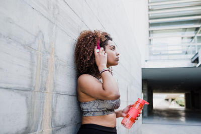 Curvy african american woman working out and listening music