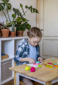 Cute boy playing with toy in classroom