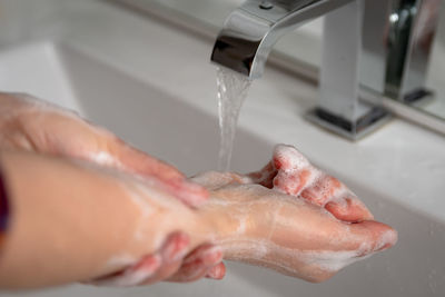 Midsection of man in bathroom at home