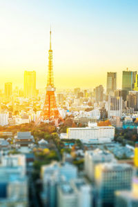 Modern buildings in city against sky during sunset