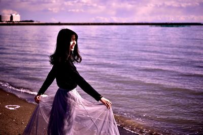 Side view of woman in water at sea