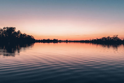 Scenic view of lake against sky during sunset