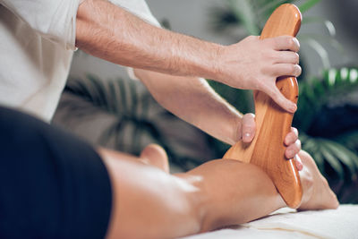 Midsection of man giving massage to woman