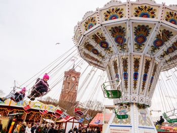 Low angle view of illuminated ferris wheel against sky