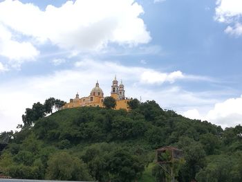 View of temple building against cloudy sky