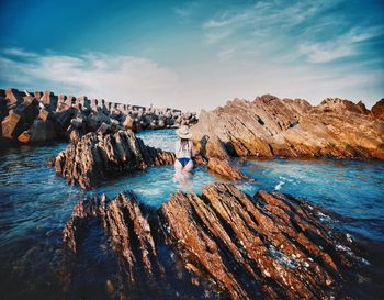 Panoramic view of rocks in sea against sky