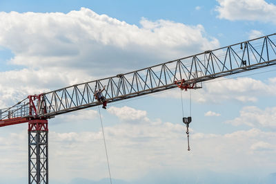 Low angle view of crane against sky