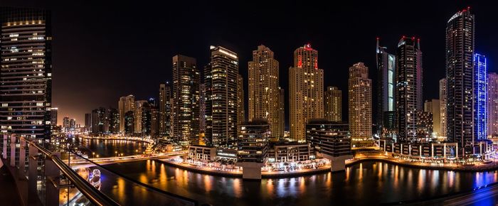 Illuminated modern buildings in city at night