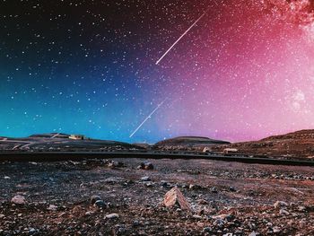 Scenic view of mountains against sky at night