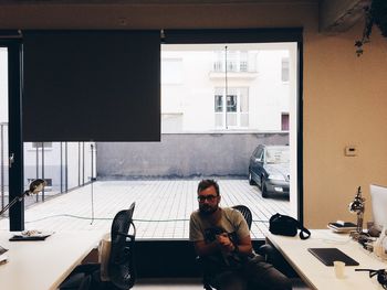 Portrait of mature man sitting on chair in office