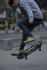 Low section of boy skateboarding on skateboard