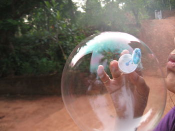 Close-up of hand holding bubbles