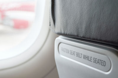 Close-up of information sign on airplane seat