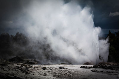 Scenic view of clouds over waterfall