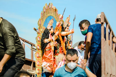 Group of a men carrying an idol of goddess durga for visarjan, guwahati,assam