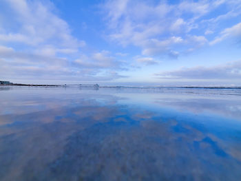 Scenic view of sea against blue sky