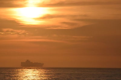 Scenic view of sea against orange sky