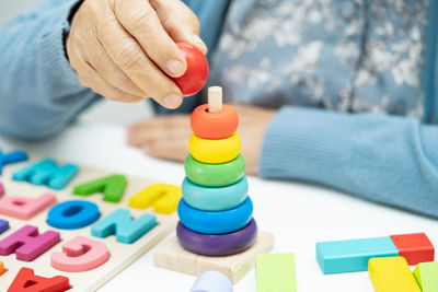 Midsection of man playing with toy blocks