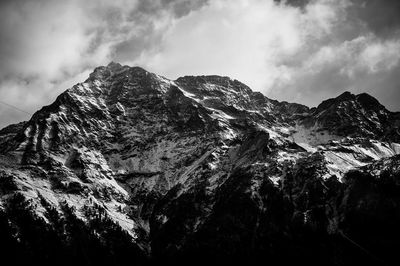 Scenic view of mountains against cloudy sky