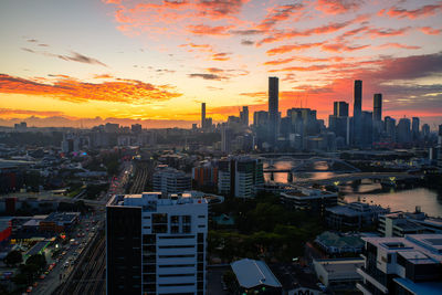 High angle view of modern buildings against sky during sunset