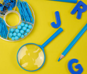 Directly above shot of tape measure on yellow background