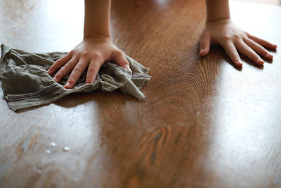 Low section of woman legs on table