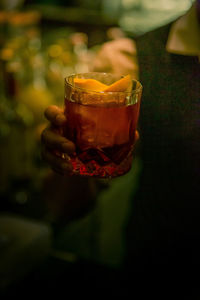 Close-up of hand holding glass of drink