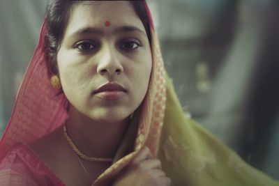 Close-up portrait of mid adult woman wearing sari at home