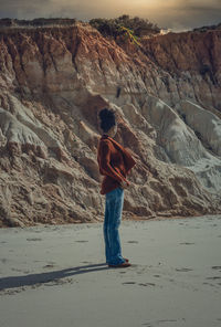 Rear view of man standing on rock